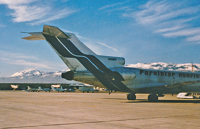 A Purolator Courier B727-100 at Reno, Nevada in early 1986. My home [now] is on the hills at the left.
